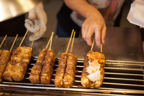 ある人が竹筺に食べ物の串を置いているところです。