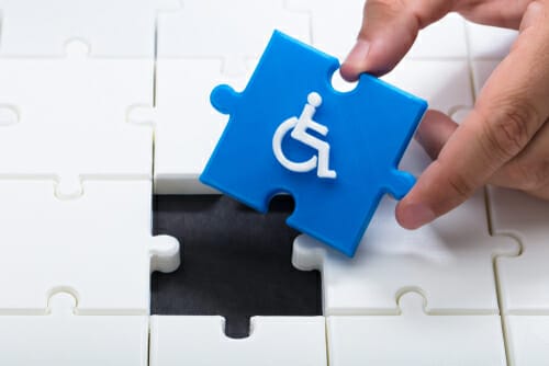 Human,Hand,Solving,Jigsaw,Puzzle,With,Blue,Piece,Having,Handicap