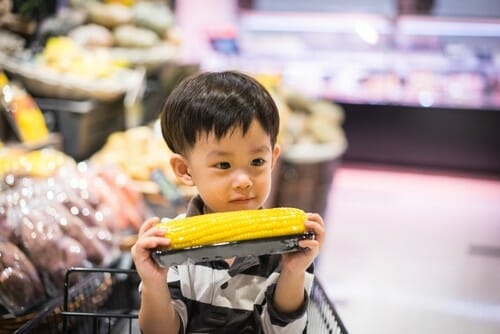 A,Boy,Is,Shopping,With,His,Mom,In,A,Supermarket.