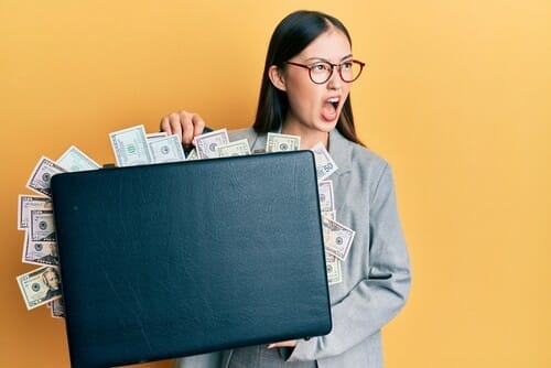 Young,Chinese,Woman,Holding,Briefcase,Full,Of,Dollars,Angry,And