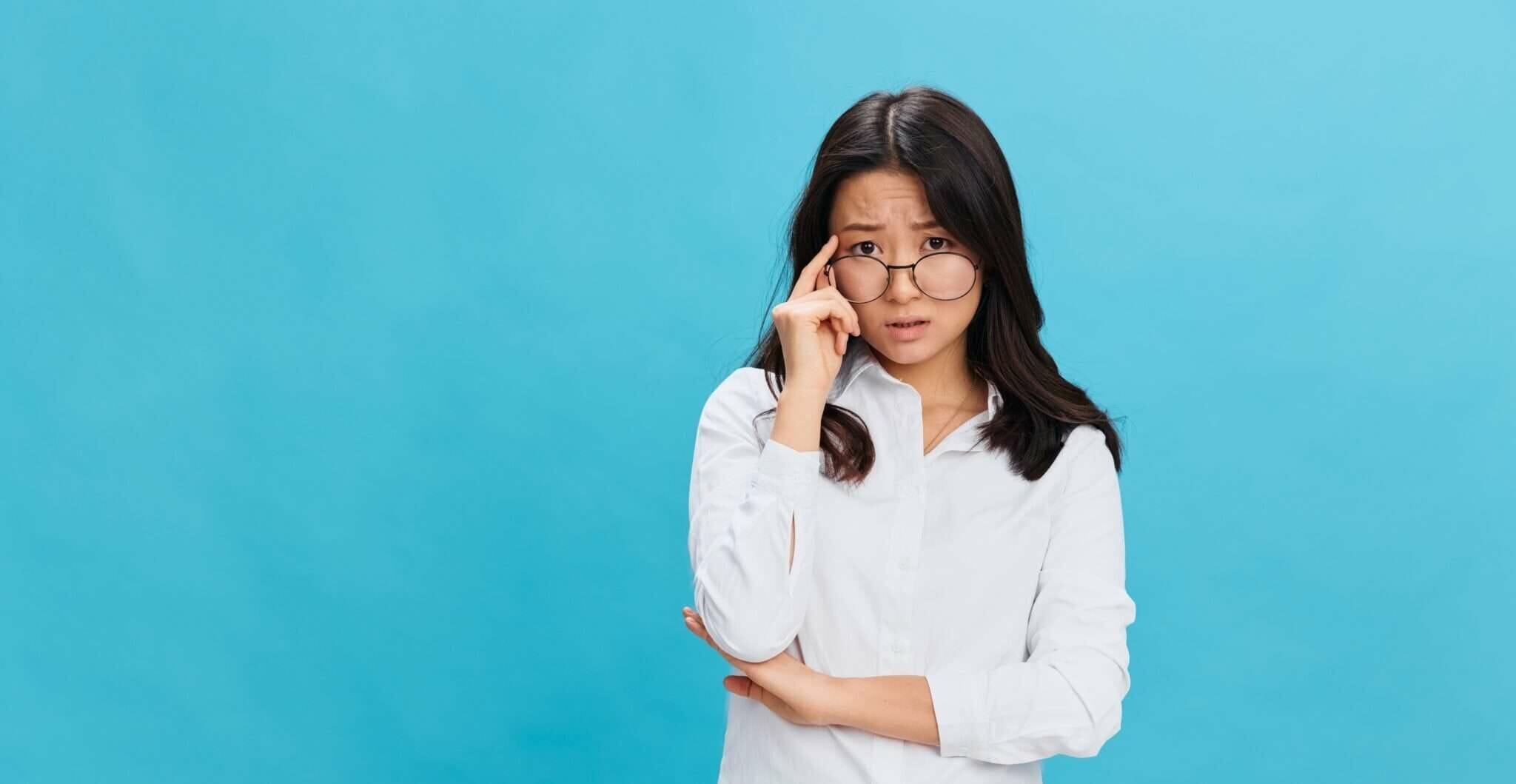 一人の眼镜台に白色衫を着た年轻亚洲女性、背景