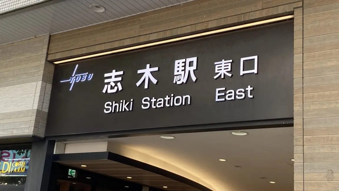 入り口の上の看板には、英語と日本語で「志木駅東口」と書かれており、駅の東口を示している。.